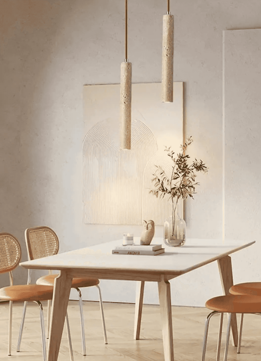 Nowoczesne lampy wiszące w kształcie walca nad jasnym stołem kuchennym z dekoracjami