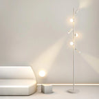 Nowoczesna lampa podłogowa JIANKEXING z kulistymi źródłami światła w jasnym minimalistycznym salonie
