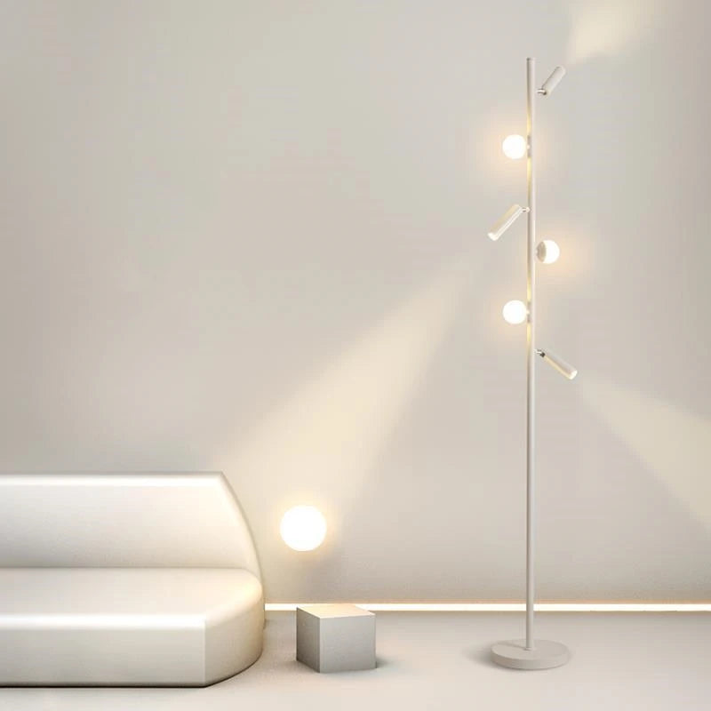 Nowoczesna lampa podłogowa JIANKEXING z kulistymi źródłami światła w jasnym minimalistycznym salonie