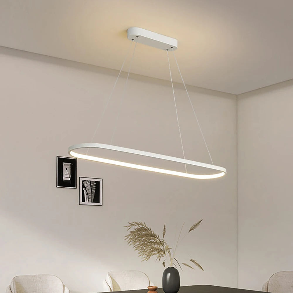 Lampa wisząca ASCELINA nowoczesna owalna biała LED zawieszona nad jadalnym stołem