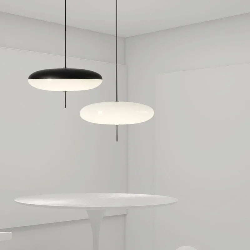 Nowoczesne lampy wiszące JIANKEXING w czarno-białym designie nad okrągłym białym stołem